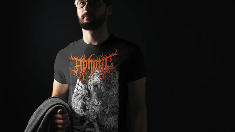 A man in a black T-shirt printed with the Aphotic logo in red over a grey creature.